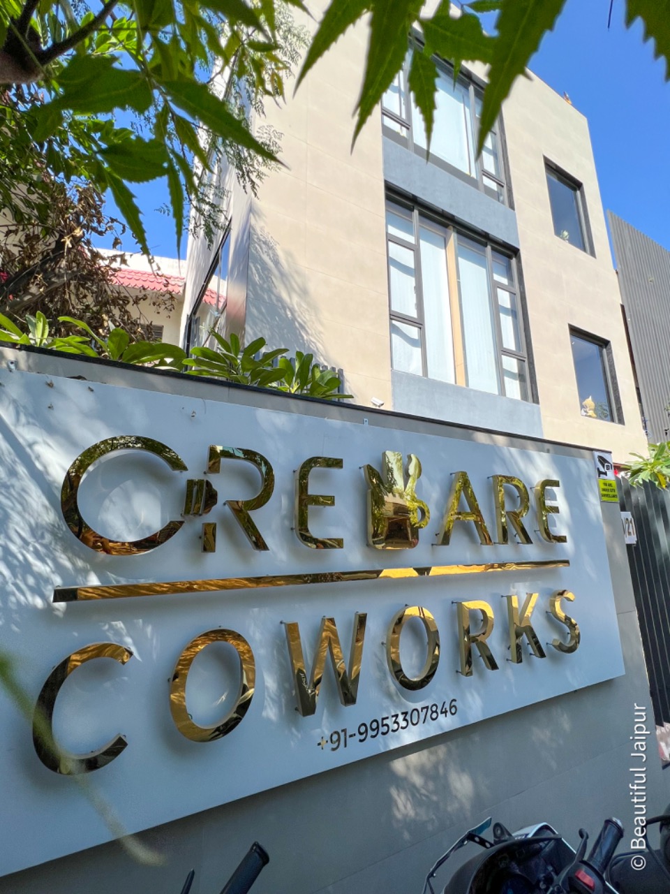 Creware Coworks gold signage at entrance