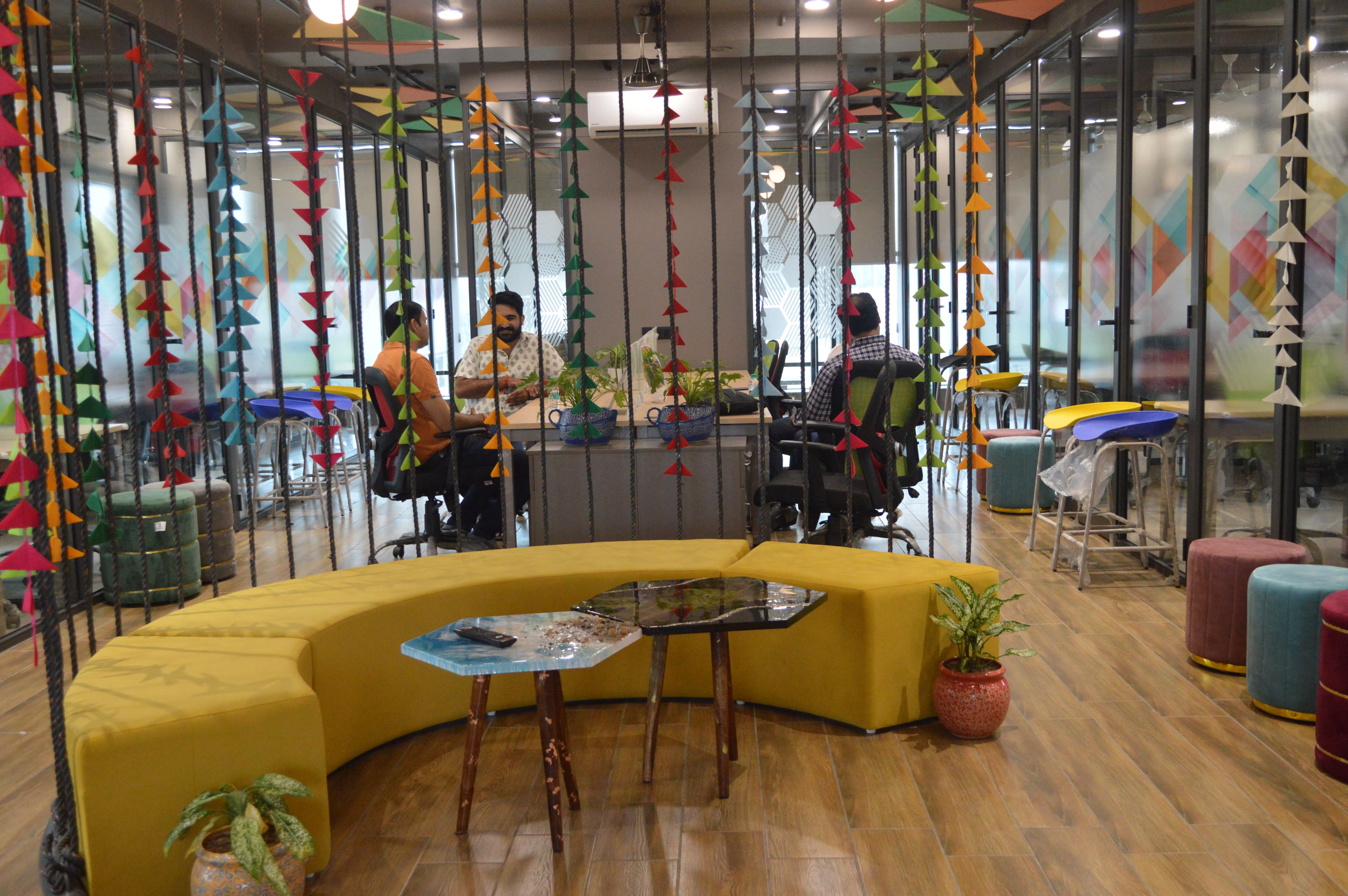 Festival-decorated lounge with curved yellow sofa